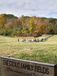 Hikers crossing Wintonbury Land Trust's Stout Family Fields