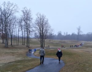 Walkers stretched out along the golf cart path